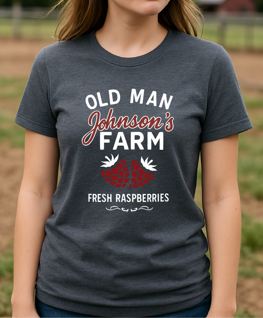 Woman wearing a t-shirt with 'Old Man Johnson's Farm' text in a farm setting
